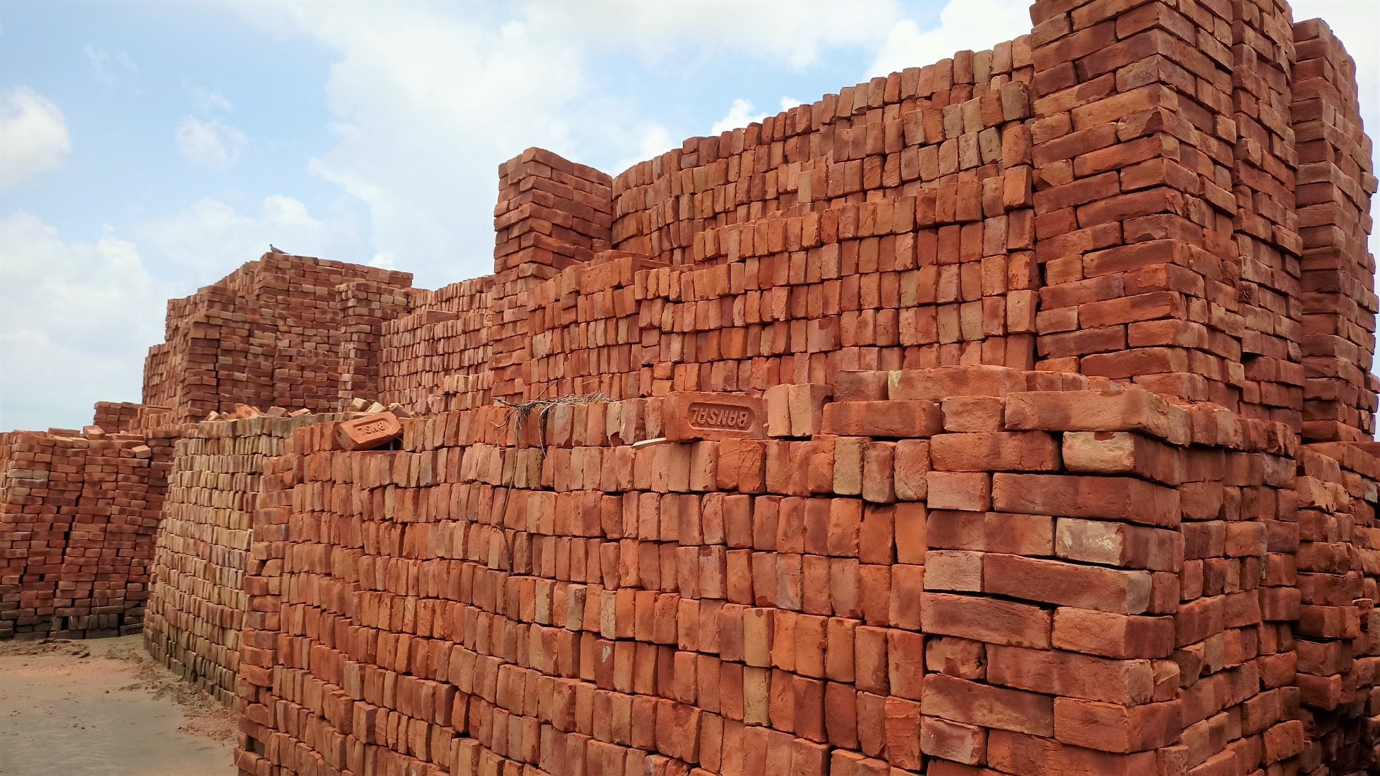 Construction site with bricks and building materials at sunset