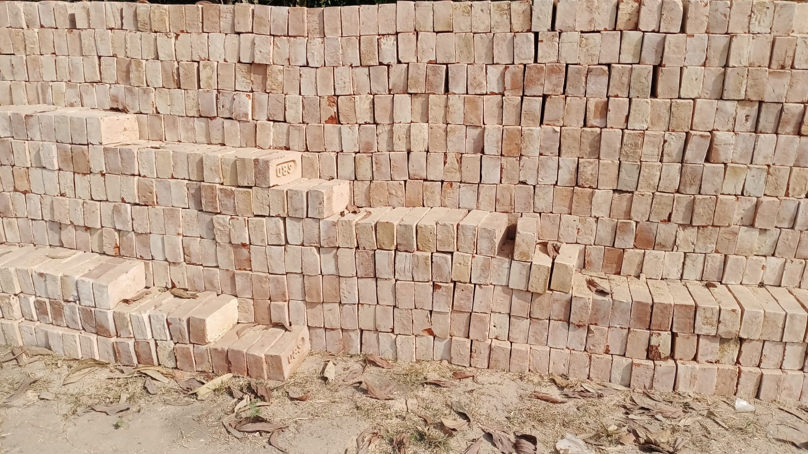 Stack of red bricks and construction materials
